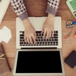 freelancer analyzing upwork fees and income on laptop workspace