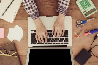 freelancer analyzing upwork fees and income on laptop workspace