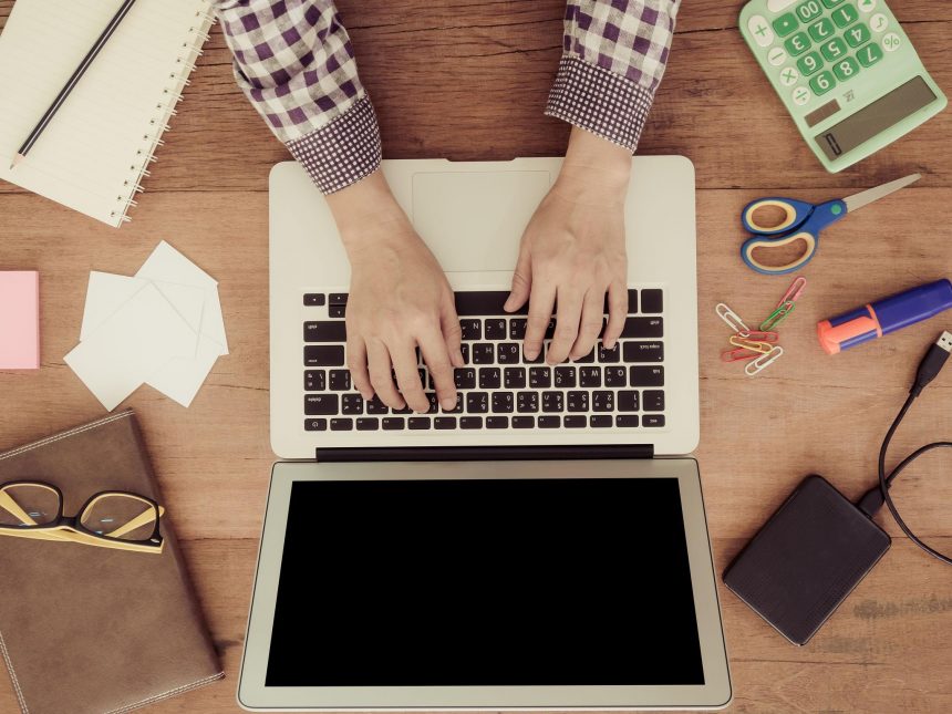 freelancer analyzing upwork fees and income on laptop workspace