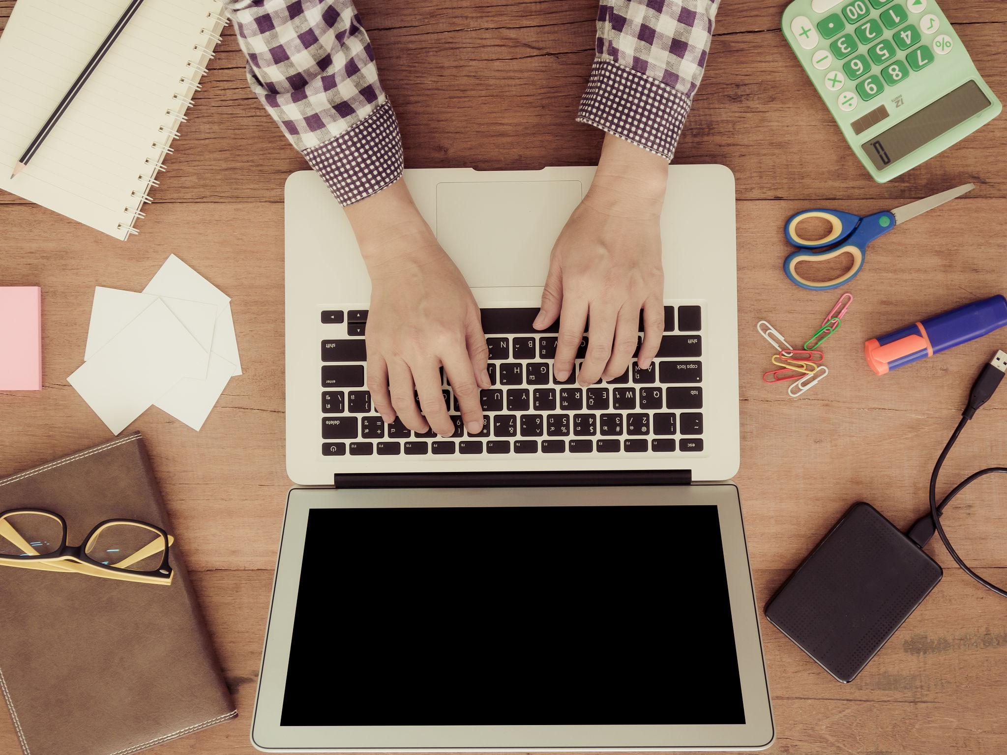 freelancer analyzing upwork fees and income on laptop workspace